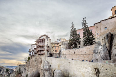 Low angle view of old building against cloudy sky