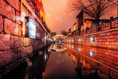 Reflection of illuminated buildings in canal