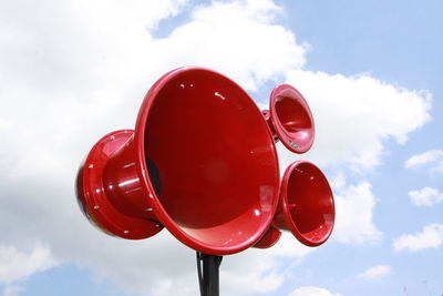 Low angle view of red balloons against sky