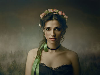 Portrait of a beautiful young woman against blue sky