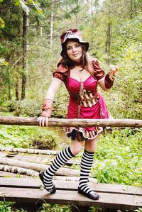 Portrait of happy girl standing in forest