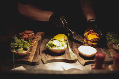 Midsection of man preparing food on cutting board