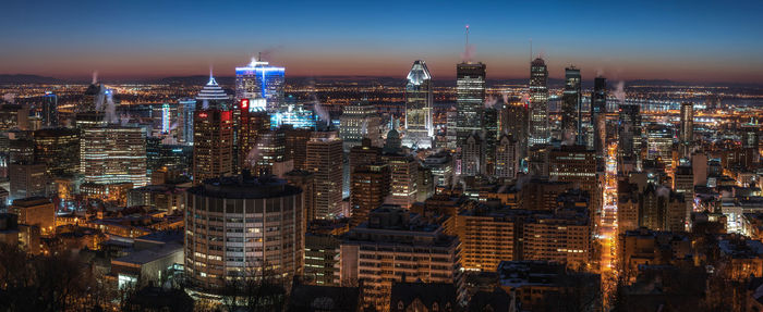 Aerial view of city lit up at night