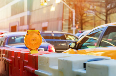 Close-up of yellow car on street