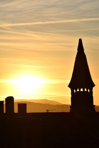 Silhouette temple against sky during sunset