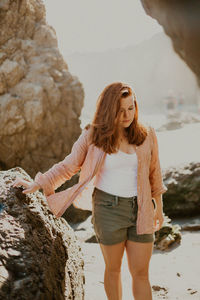 Full length of woman standing on rock