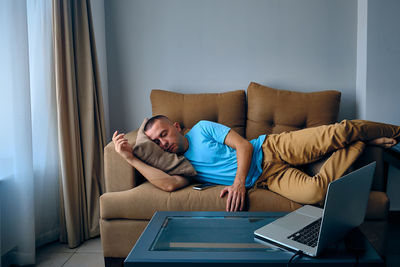 Young woman using laptop at home