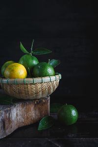 Close-up of oranges in wicker basket on table