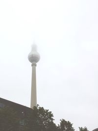 Low angle view of communications tower against sky