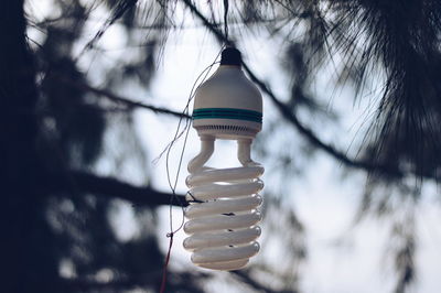 Low angle view of light bulb against sky