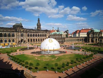 Buildings in city against cloudy sky