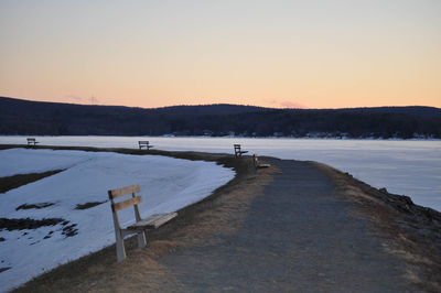 Scenic view of lake against clear sky during sunset