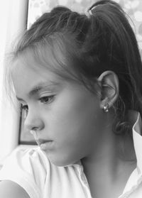 Close-up of girl looking away at home