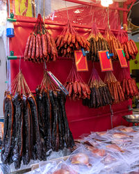 Hanging dried sausages and meat products in a butcher shop display. singapore, chinatown