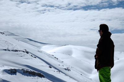 Man standing on snow covered landscape