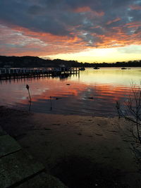 Scenic view of lake against orange sky