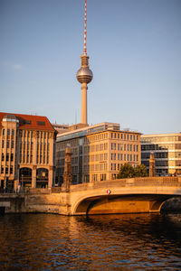 Bridge over river with buildings in background