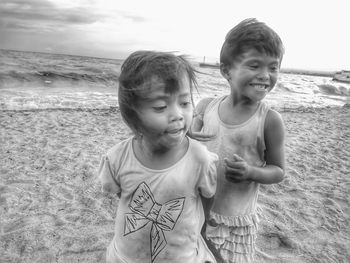 Portrait of happy girl standing on beach