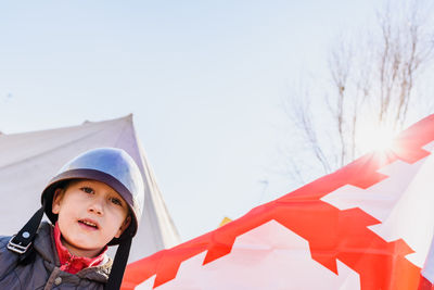 Low angle view portrait of boy against sky