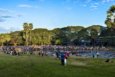 People at music concert against sky