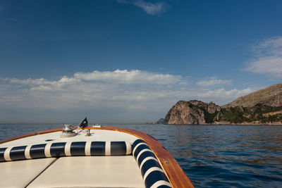 Boat sailing on sea against sky