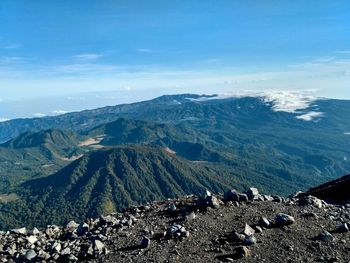 Aerial view of volcanic landscape against blue sky