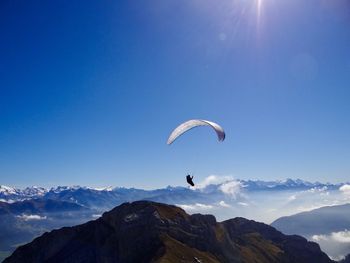 Person paragliding against sky