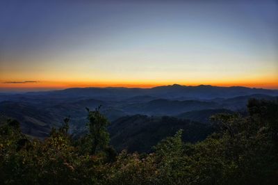 Scenic view of mountains against sky at sunset