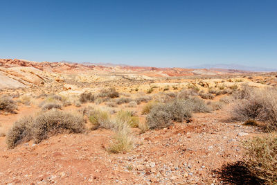 Scenic view of desert against clear blue sky