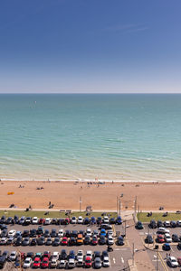 High angle view of people on beach against clear sky