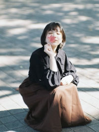 Portrait of a girl standing on footpath