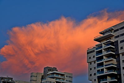 Low angle view of buildings against sky during sunset