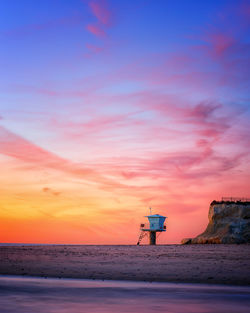 Scenic view of beach against sky during sunset