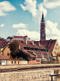 Buildings in town against sky