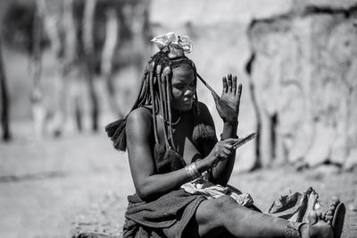 Young woman sitting outdoors