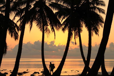 Silhouette man at beach during sunset