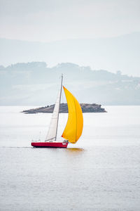 Boat sailing on sea against sky