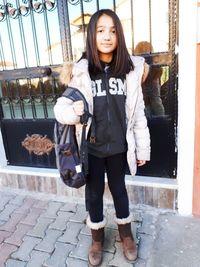 Portrait of smiling girl standing outdoors