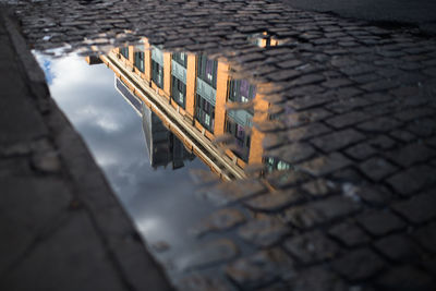 High angle view of building reflecting in puddle