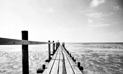 Pier over sea against sky