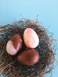 Close-up of chocolate easter eggs in birds nest on table