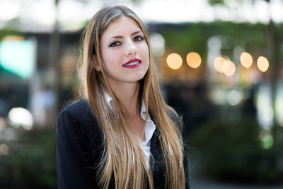 Portrait of beautiful young woman standing outdoors