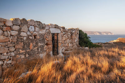 Abandoned house on the coast of milos island, cyclades, greece