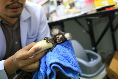 Midsection of man holding paper at home