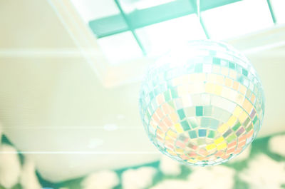 Low angle view of illuminated ball hanging from ceiling