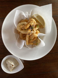 High angle view of fried calamari food in plate on table