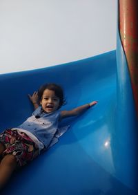 Portrait of cute girl playing on slide