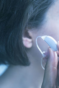 Close-up of woman with hearing aid