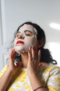 Woman with facial mask at spa