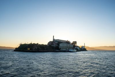 Scenic view of sea against clear sky during sunset